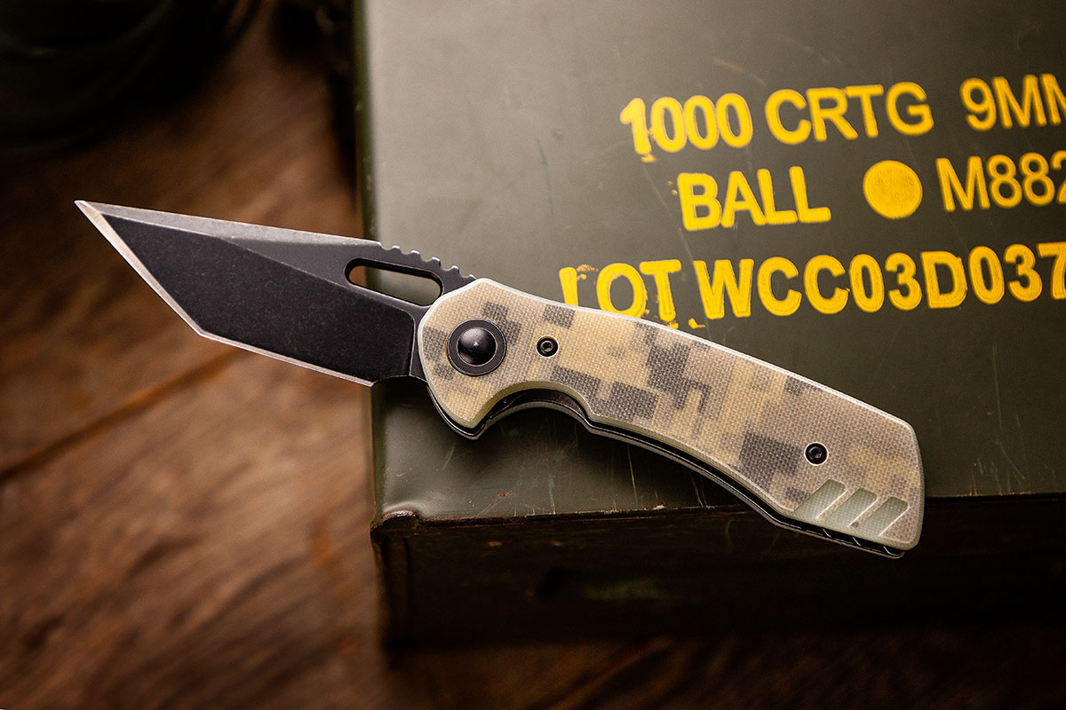 BRS E-Volve Nomad with Camo G10 handles sitting on an ammo can