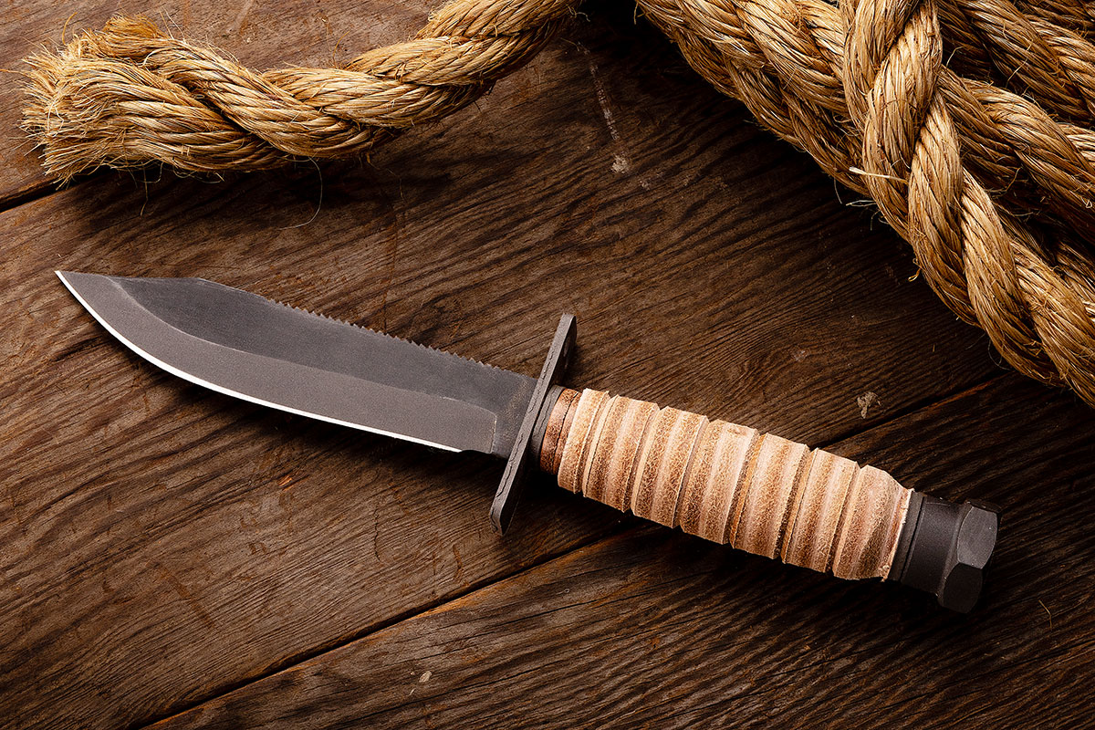 Ontario Air Force Survival Knife set next to manilla rope