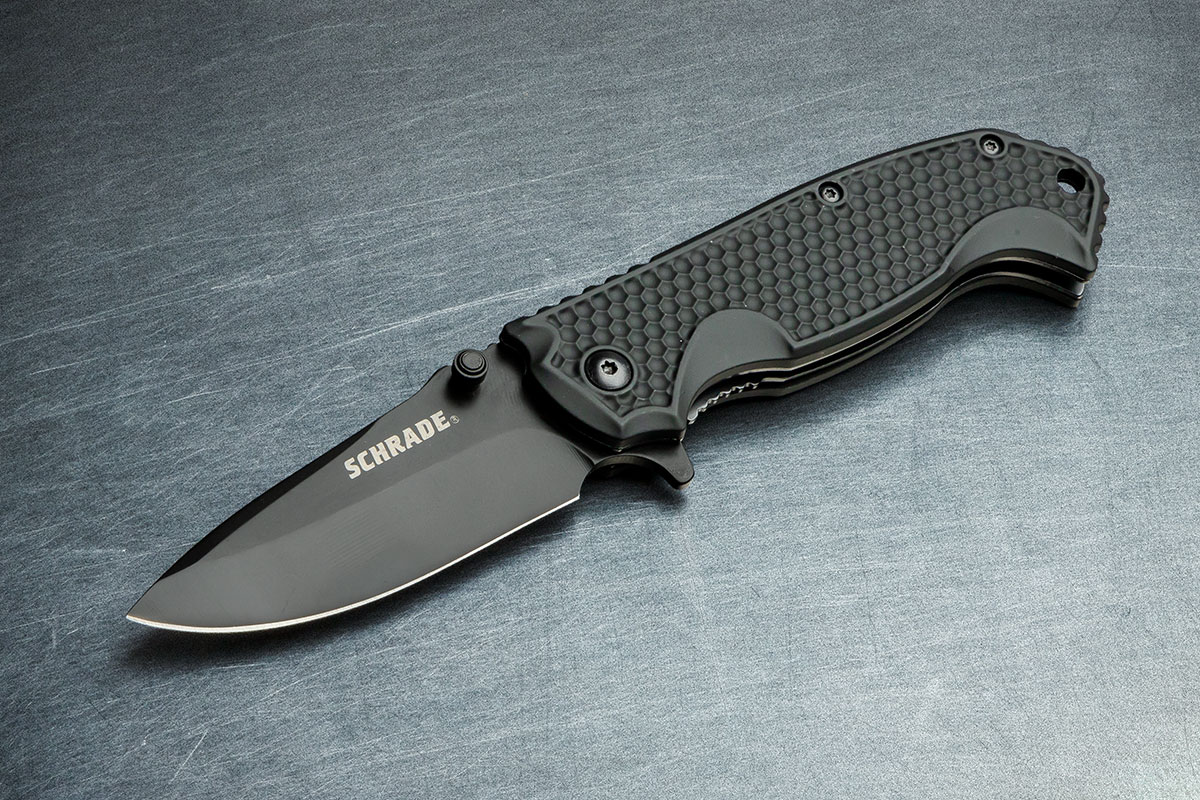 Schrade SCH001 Flipper open on a brushed steel background
