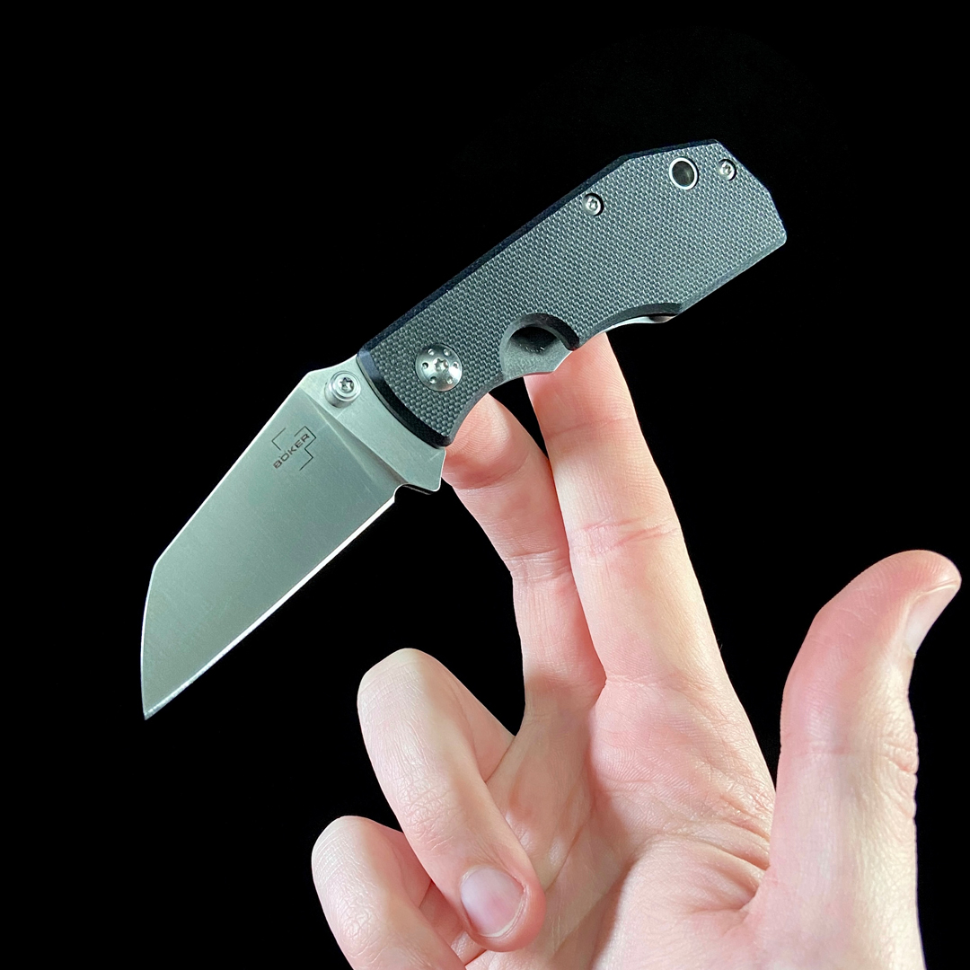 Boker Reinhold Folding Knife in hand, black background