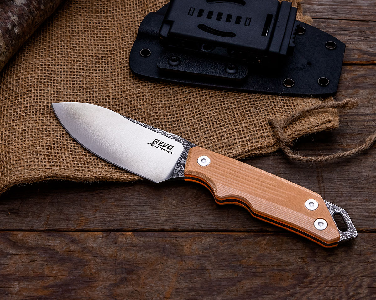 REVO RJ1 Journey fixed blade, natural, next to sheath on top of burlap sack