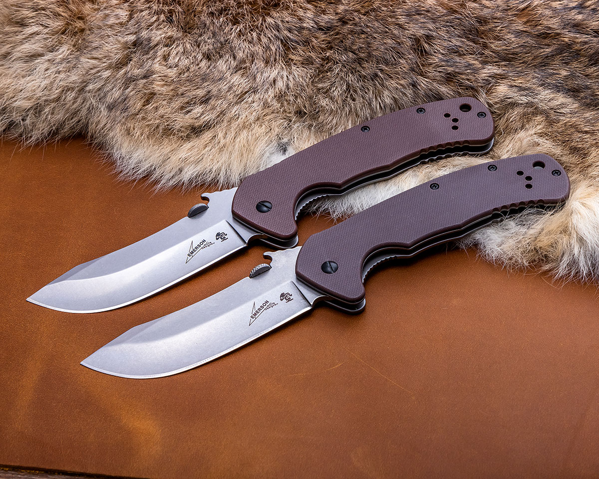 Pair of open Kershaw Emerson CQC-11K folders on a pelt