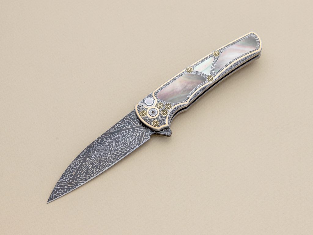 Pro-Tech Malibu engraved knife on beige background