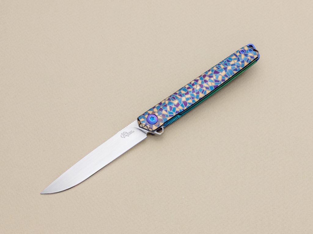 Ken Onion custom knife on beige background