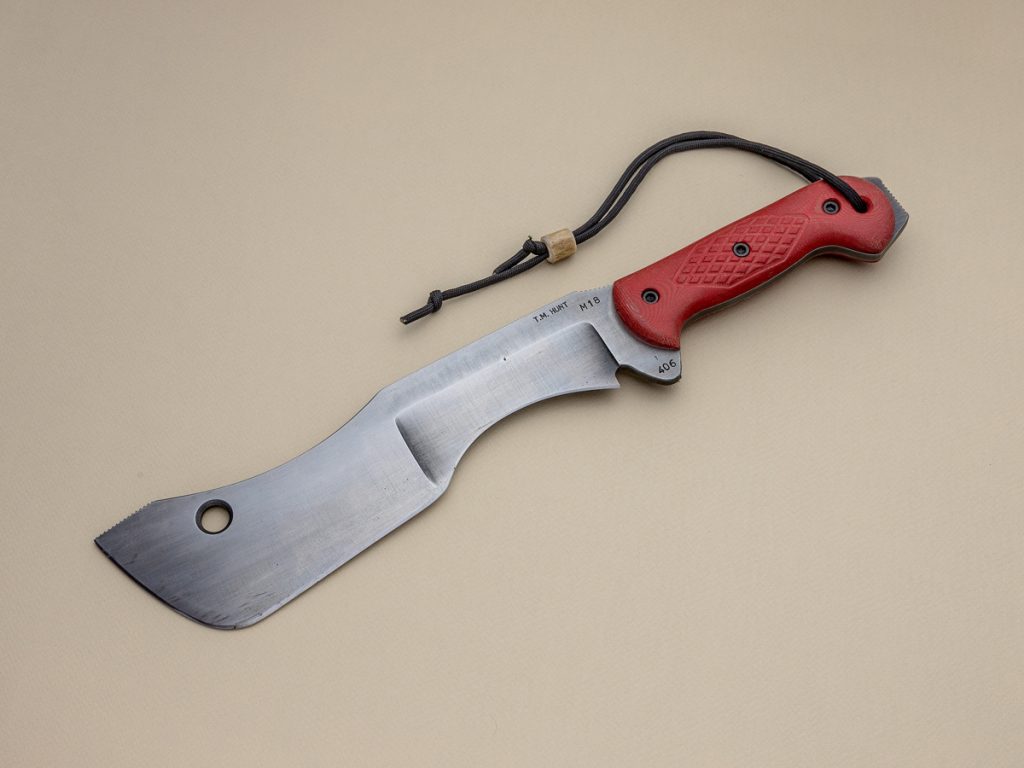 TM Hunt M18 fixed blade machete on beige background