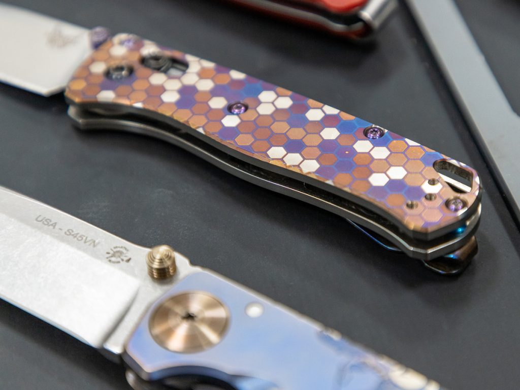 Close-up of custom titanium Benchmade Bugout scales