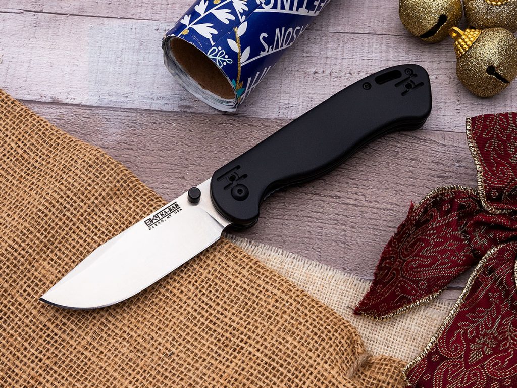 KA-BAR Becker BK40 folding knife open on a holiday themed background