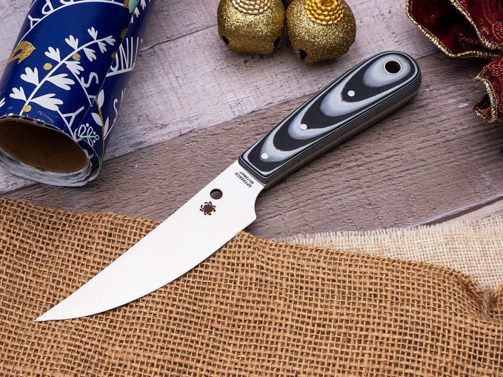 Spyderco Bow River fixed blade knife on a holiday themed background