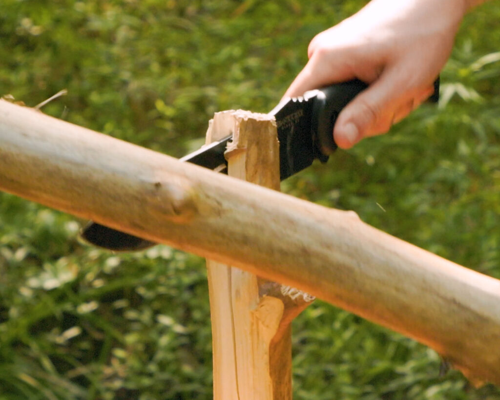 Batoning a Becker BK 9 fixed blade through a small wooden branch