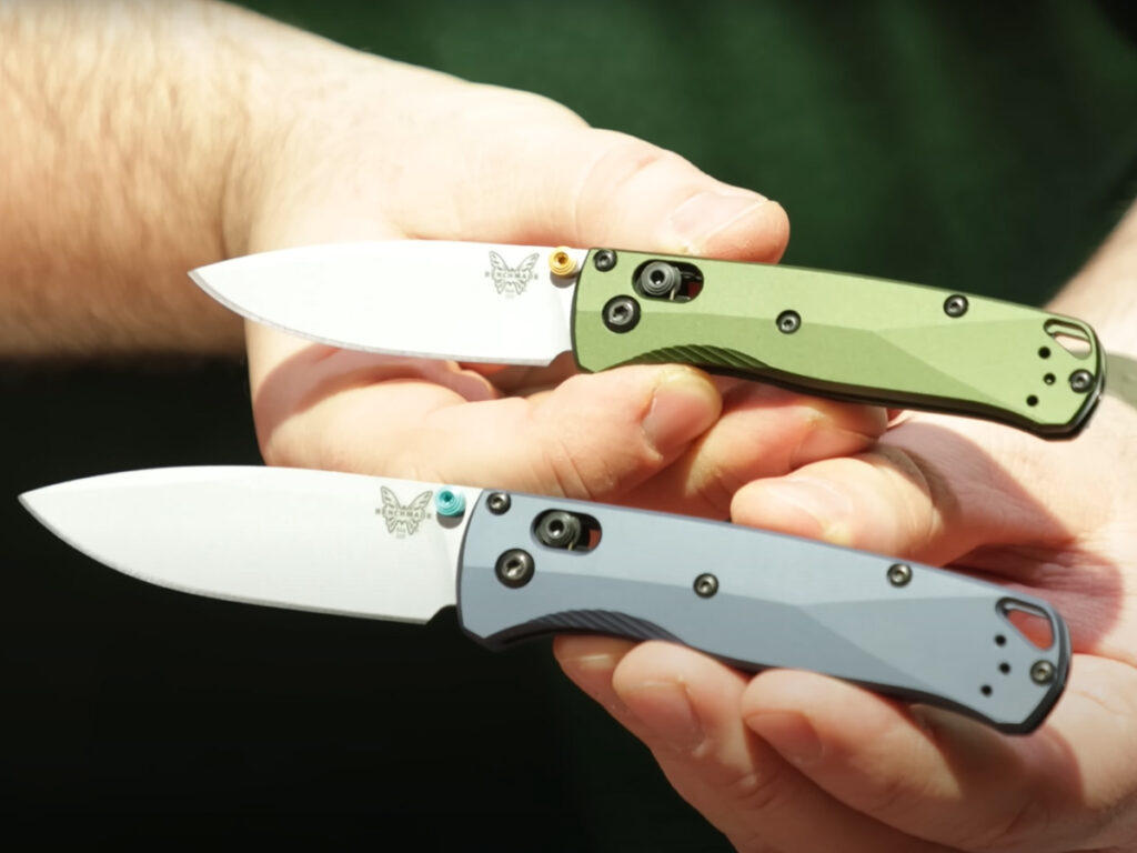 Benchmade Bugout and Mini Bugout folding knives open in hand