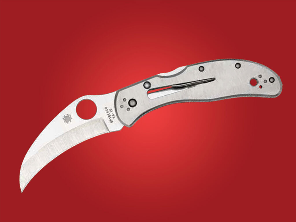 Spyderco Harpy knife open on red background