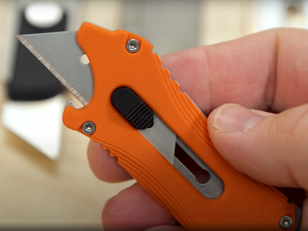 Olight Otace Utility knife displayed in hand