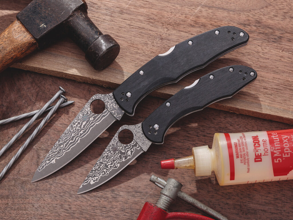 Spyderco Endura and Delica folding knives open on wood background