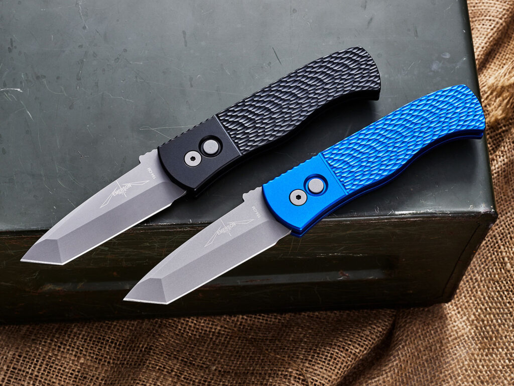 Two Pro-Tech Emerson CQC7 Tanto switchblades sitting side-by-side on an ammo can