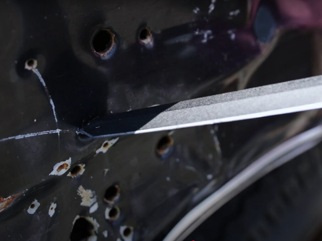 Tanto blade piercing a car door