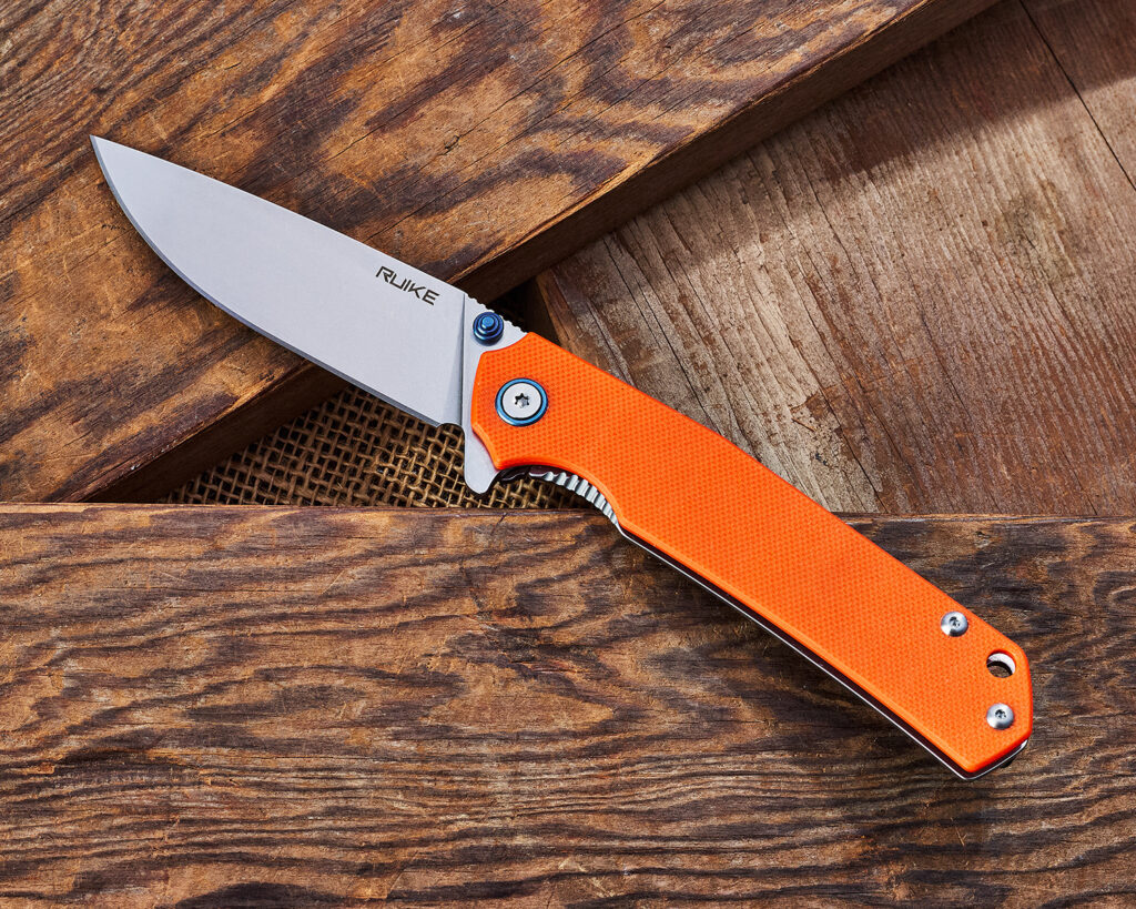 RUIKE P801 G10 knife on a stack of wood